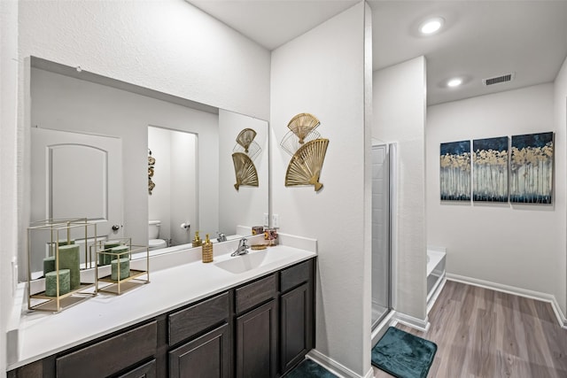 11034 Hillside Creek Dr, Humble, TX 77396 - bathroom with wood finished floors, vanity, a bath, a shower stall, and recessed lighting