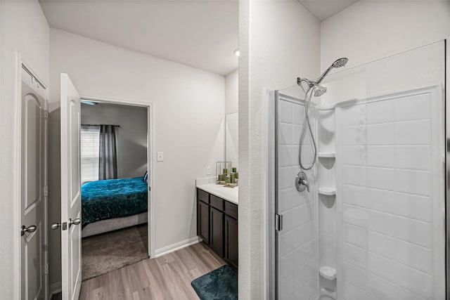 11034 Hillside Creek Dr, Humble, TX 77396 - bathroom featuring wood finished floors, a shower stall, vanity, and ensuite bath