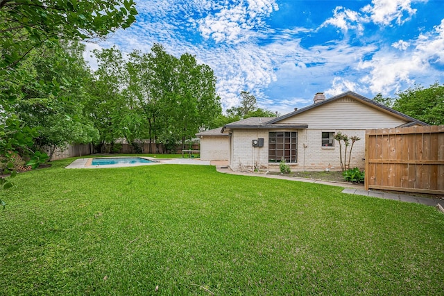 13506 Sherwood St, Sugar Land, TX 77498 - back of property featuring a fenced backyard, a chimney, brick siding, and a patio