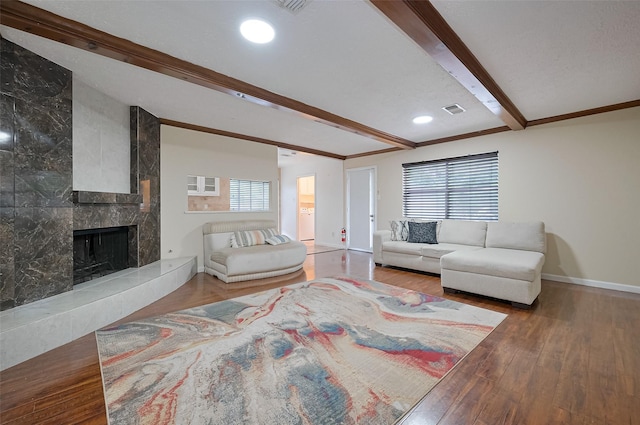 13506 Sherwood St, Sugar Land, TX 77498 - living room featuring beam ceiling, wood finished floors, and a premium fireplace