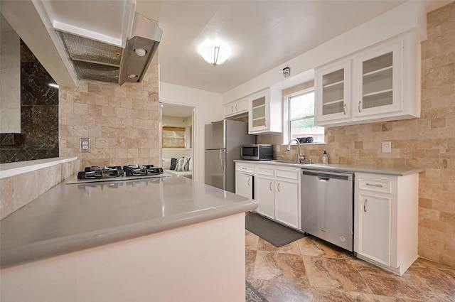 13506 Sherwood St, Sugar Land, TX 77498 - kitchen with stainless steel appliances, exhaust hood, white cabinetry, and light countertops