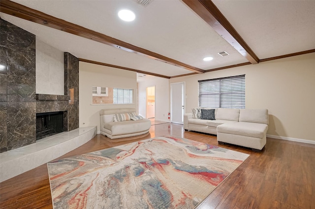 13506 Sherwood St, Sugar Land, TX 77498 - living area featuring beamed ceiling, wood finished floors, and a high end fireplace