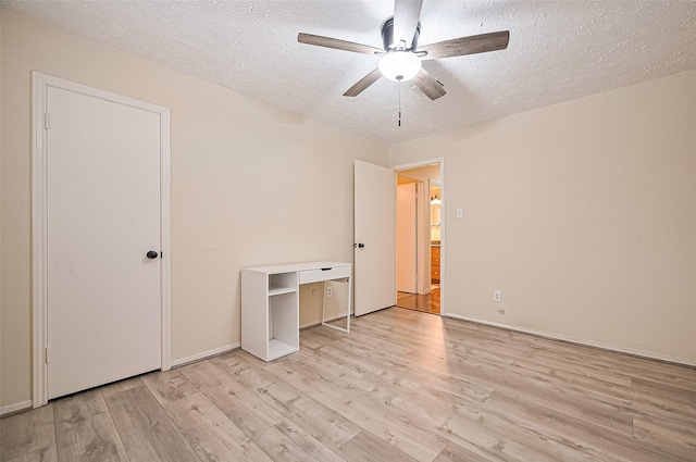 13506 Sherwood St, Sugar Land, TX 77498 - unfurnished bedroom featuring light wood finished floors, a textured ceiling, and a ceiling fan