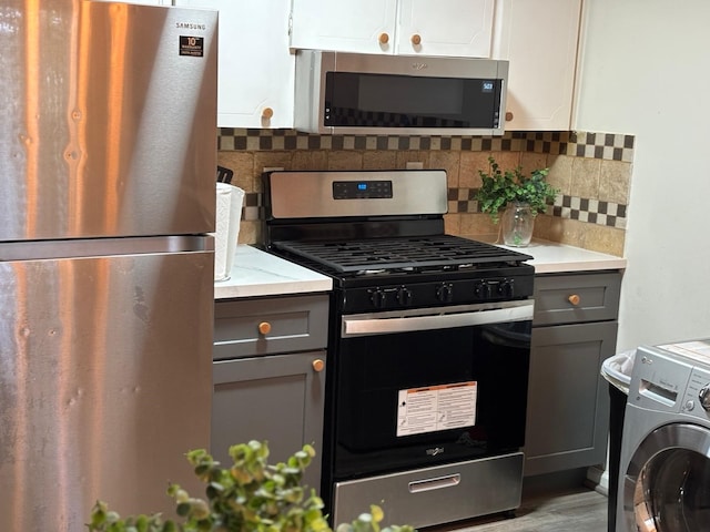 1529 Wirt Rd Unit 6, Houston, TX 77055 - kitchen with stainless steel appliances, washer / clothes dryer, gray cabinets, light countertops, and decorative backsplash