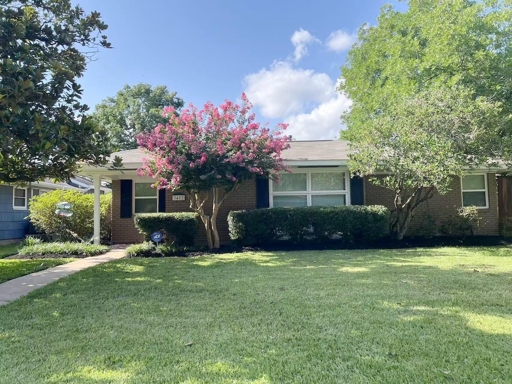 3402 Gannett St, Houston, TX 77025 - view of property hidden behind natural elements with brick siding and a front yard