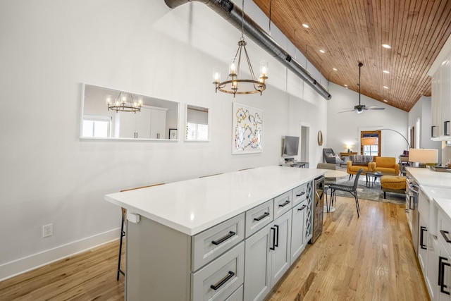 703 Dumble St, Houston, TX 77023 - kitchen featuring a chandelier, ceiling fan, light countertops, a kitchen island, and high vaulted ceiling