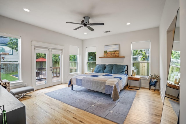 703 Dumble St, Houston, TX 77023 - bedroom featuring access to outside, multiple windows, light wood-style flooring, french doors, and recessed lighting