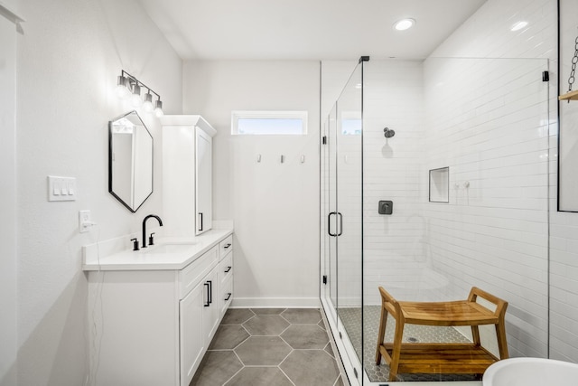 703 Dumble St, Houston, TX 77023 - full bathroom featuring vanity, a stall shower, tile patterned flooring, and recessed lighting