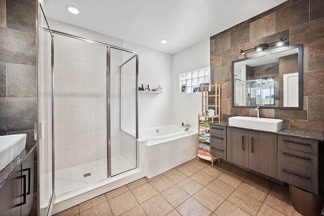 2010 Blodgett St Unit G, Houston, TX 77004 - bathroom with vanity, a garden tub, a shower stall, tile walls, and recessed lighting