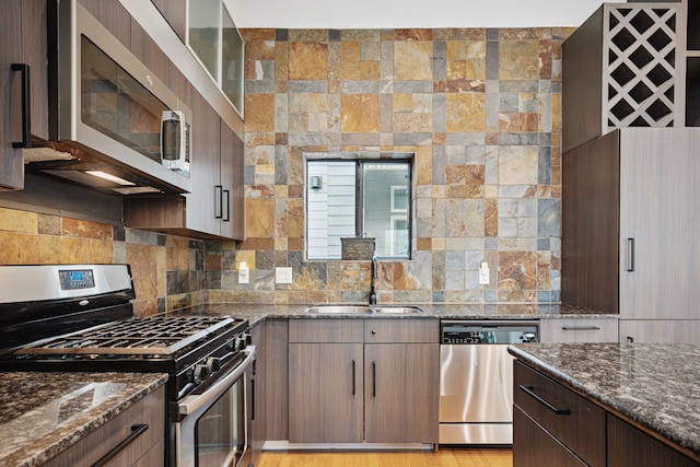2010 Blodgett St Unit G, Houston, TX 77004 - kitchen with stainless steel appliances, dark stone countertops, and tasteful backsplash