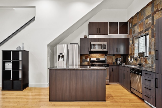 2010 Blodgett St Unit G, Houston, TX 77004 - kitchen with stainless steel appliances, a kitchen island, dark brown cabinetry, and tasteful backsplash