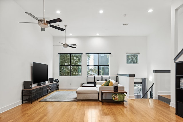 2010 Blodgett St Unit G, Houston, TX 77004 - living area featuring a towering ceiling, ceiling fan, healthy amount of natural light, wood finished floors, and recessed lighting