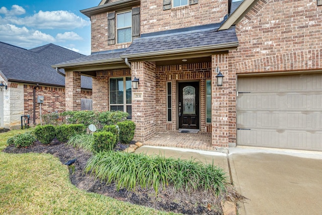 2131 Blossomcrown Dr, Katy, TX 77494 - entrance to property featuring brick siding, a shingled roof, a garage, driveway, and covered porch