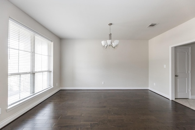 2131 Blossomcrown Dr, Katy, TX 77494 - unfurnished room featuring a chandelier, healthy amount of natural light, and dark wood-style floors