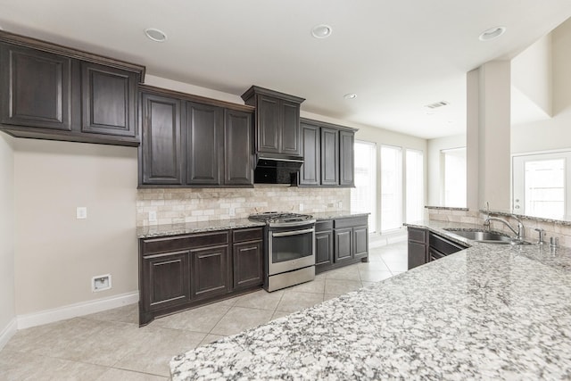 2131 Blossomcrown Dr, Katy, TX 77494 - kitchen with gas range, tasteful backsplash, healthy amount of natural light, light stone counters, and recessed lighting
