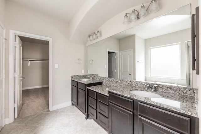 2131 Blossomcrown Dr, Katy, TX 77494 - bathroom with double vanity, a spacious closet, and tile patterned floors