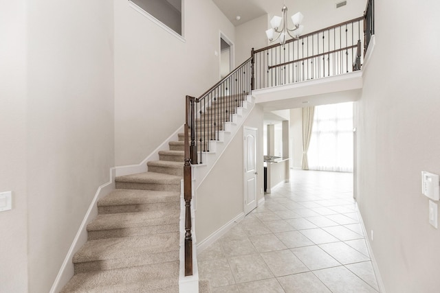 2131 Blossomcrown Dr, Katy, TX 77494 - staircase with a chandelier, tile patterned floors, and a towering ceiling