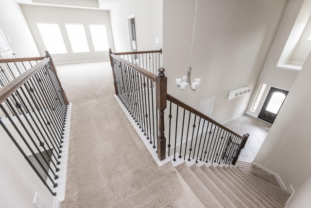 2131 Blossomcrown Dr, Katy, TX 77494 - staircase featuring carpet flooring, plenty of natural light, and a chandelier