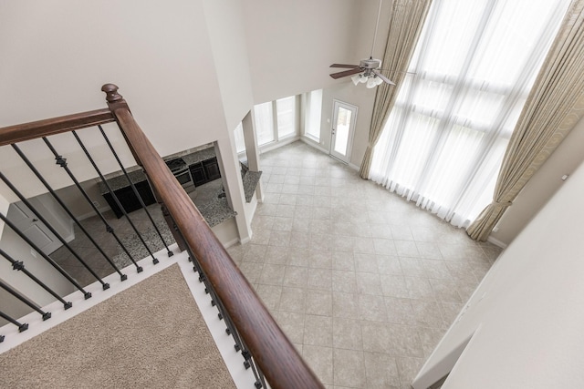 2131 Blossomcrown Dr, Katy, TX 77494 - stairs with a high ceiling, a ceiling fan, and tile patterned flooring