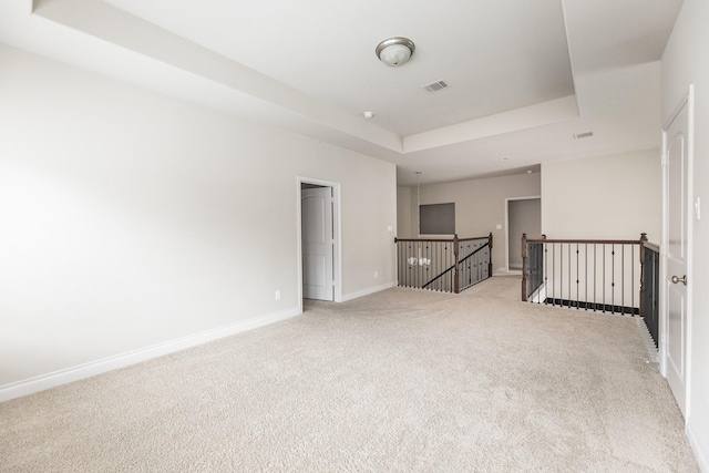 2131 Blossomcrown Dr, Katy, TX 77494 - empty room featuring a tray ceiling and light colored carpet