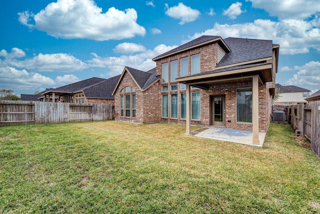 2131 Blossomcrown Dr, Katy, TX 77494 - rear view of property with brick siding, a shingled roof, a patio area, and a fenced backyard