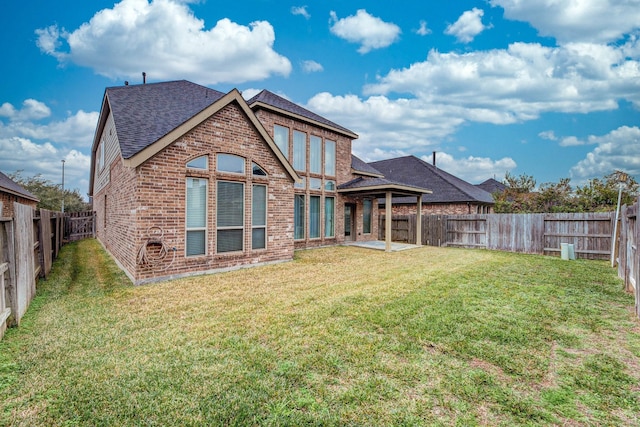 2131 Blossomcrown Dr, Katy, TX 77494 - rear view of house featuring brick siding, a shingled roof, a fenced backyard, and a patio area