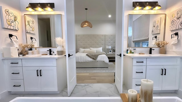 1918 Hoskins Dr, Houston, TX 77080 - bathroom with two vanities, connected bathroom, and marble look tile flooring