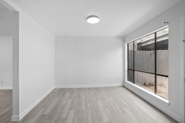 9005 Imogene St Unit C, Houston, TX 77036 - unfurnished room featuring wood finished floors and baseboards