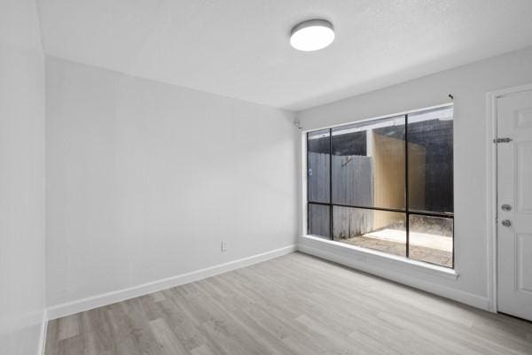 9005 Imogene St Unit C, Houston, TX 77036 - spare room featuring wood finished floors and healthy amount of natural light