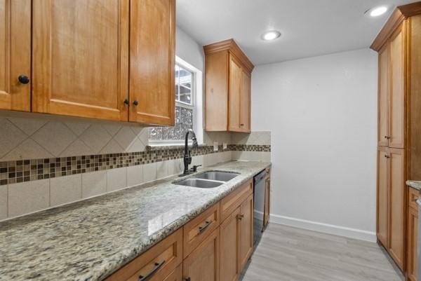 9005 Imogene St Unit C, Houston, TX 77036 - kitchen featuring light wood-style flooring, tasteful backsplash, light stone countertops, dishwasher, and recessed lighting