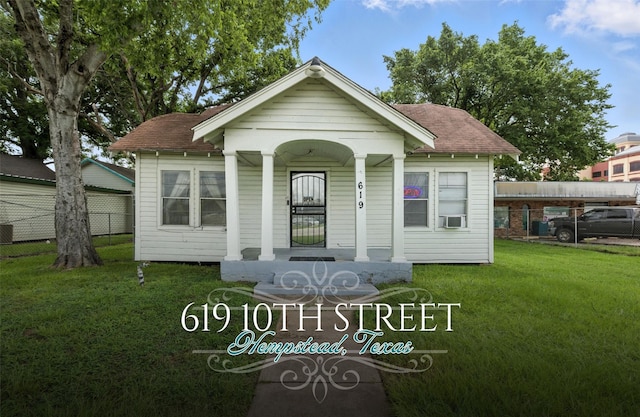 619 10th St, Hempstead, TX 77445 - view of front of house featuring a porch, a shingled roof, and cooling unit
