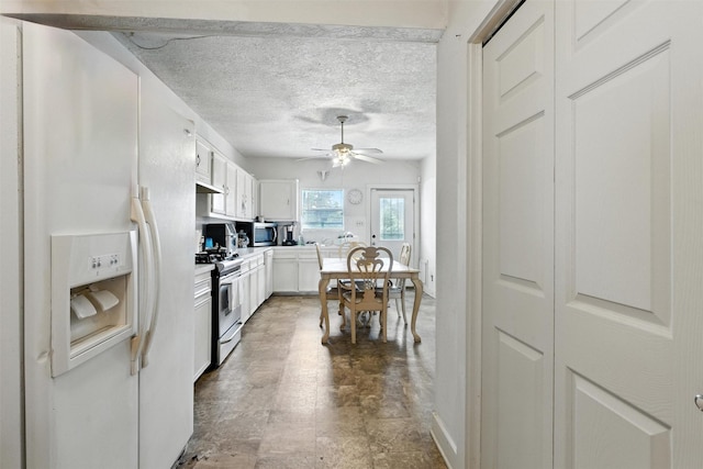 619 10th St, Hempstead, TX 77445 - kitchen with stainless steel appliances, white cabinets, ceiling fan, light countertops, and a textured ceiling