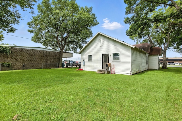 619 10th St, Hempstead, TX 77445 - back of house featuring a yard and entry steps