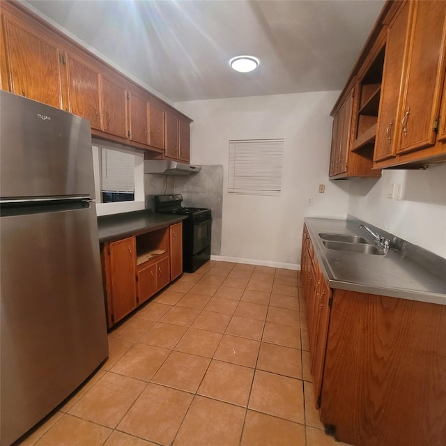 1814 Gano St, Houston, TX 77009 - kitchen featuring freestanding refrigerator, black range, open shelves, under cabinet range hood, and brown cabinetry
