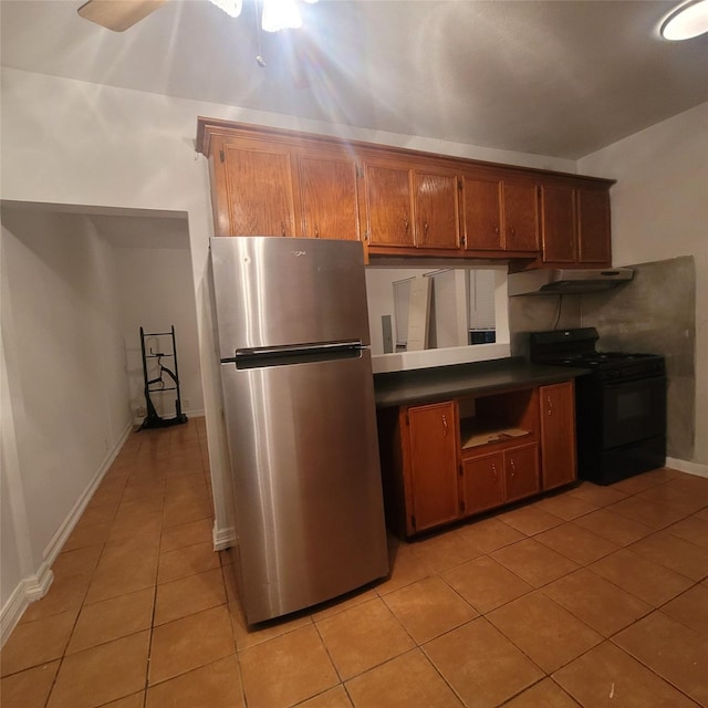 1814 Gano St, Houston, TX 77009 - kitchen featuring freestanding refrigerator, black electric range, dark countertops, light tile patterned flooring, and brown cabinets