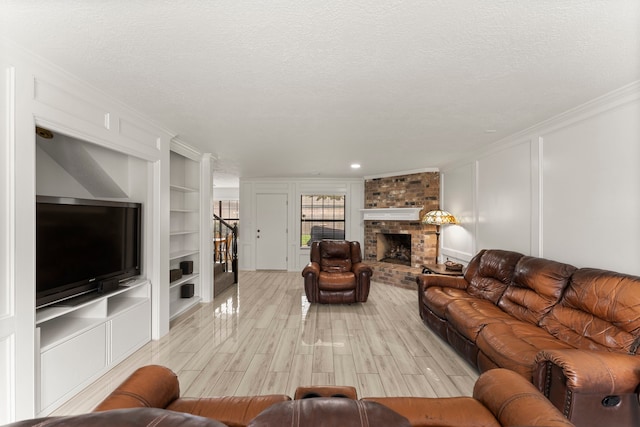 2811 Blue Glen Ln, Houston, TX 77073 - living room featuring a decorative wall, ornamental molding, built in shelves, stairway, and a brick fireplace