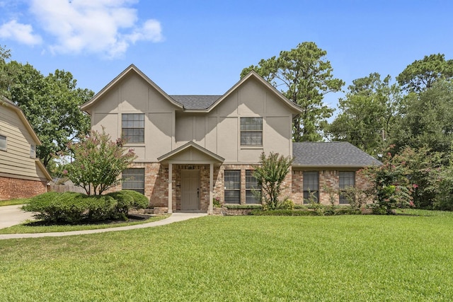 2811 Blue Glen Ln, Houston, TX 77073 - view of front of property with a front yard, brick siding, and roof with shingles