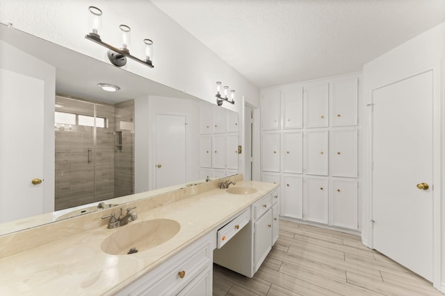 2811 Blue Glen Ln, Houston, TX 77073 - full bath featuring double vanity, a shower stall, wood finished floors, and a textured ceiling