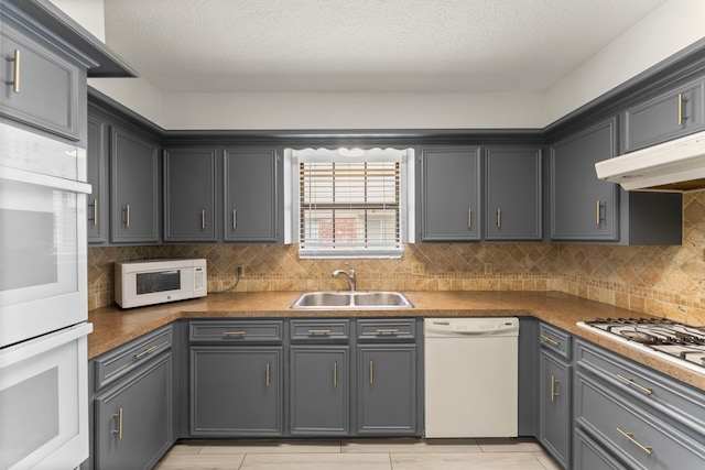 2811 Blue Glen Ln, Houston, TX 77073 - kitchen featuring white appliances, under cabinet range hood, decorative backsplash, and a textured ceiling
