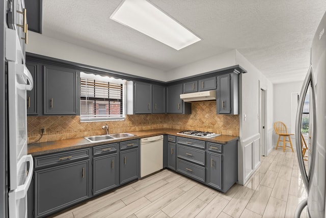 2811 Blue Glen Ln, Houston, TX 77073 - kitchen with white appliances, under cabinet range hood, dark countertops, tasteful backsplash, and a textured ceiling