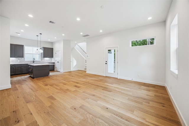 5506B Wheatley St, Houston, TX 77091 - unfurnished living room with recessed lighting, light wood-style flooring, and stairway
