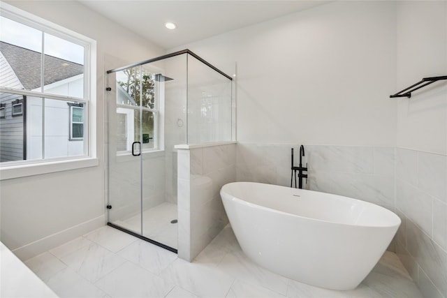 5506B Wheatley St, Houston, TX 77091 - bathroom with a freestanding bath, a stall shower, marble look tiles, and recessed lighting