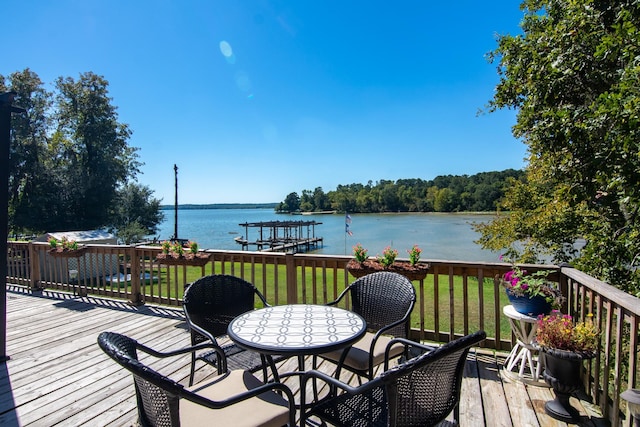 150 Edgewater Way, Point Blank, TX 77364 - wooden deck with a water view, a lawn, and outdoor dining area