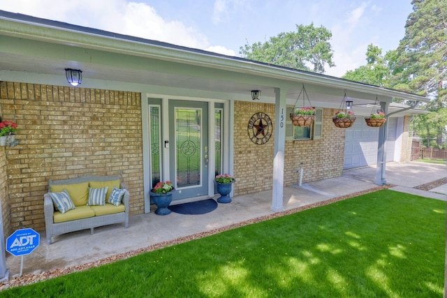 150 Edgewater Way, Point Blank, TX 77364 - doorway to property with brick siding, a porch, concrete driveway, and an attached garage