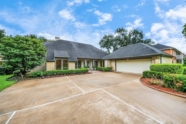 606 Montclair Blvd, Sugar Land, TX 77478 - view of front of home featuring an attached garage, brick siding, driveway, and roof with shingles