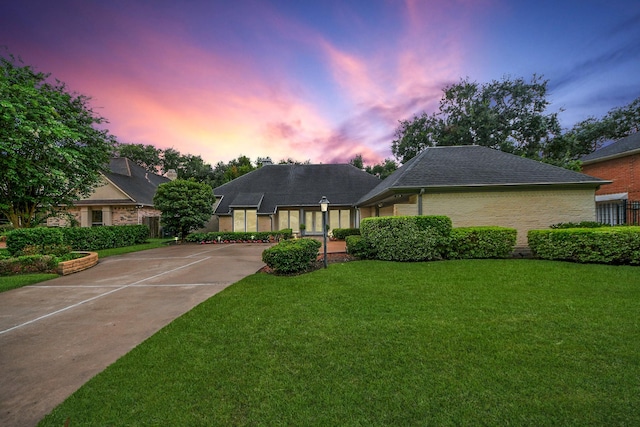 606 Montclair Blvd, Sugar Land, TX 77478 - view of front of property featuring a lawn, a shingled roof, and driveway