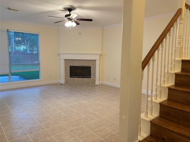 17427 Marigold Dr, Sugar Land, TX 77479 - unfurnished living room with stairway, ceiling fan, ornamental molding, a tile fireplace, and light tile patterned flooring