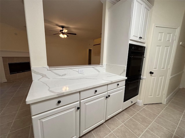 17427 Marigold Dr, Sugar Land, TX 77479 - kitchen with ceiling fan, light tile patterned flooring, white cabinetry, and light stone counters