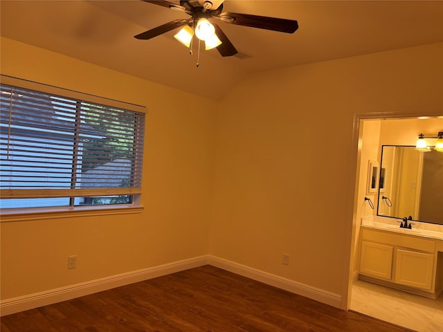 17427 Marigold Dr, Sugar Land, TX 77479 - unfurnished bedroom featuring wood finished floors, vaulted ceiling, ensuite bath, and a ceiling fan
