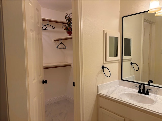 17427 Marigold Dr, Sugar Land, TX 77479 - bathroom featuring vanity and marble look tiles